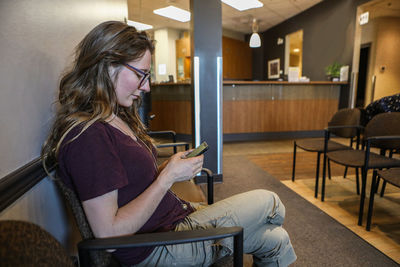 Woman sitting on chair at home