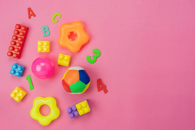 High angle view of toys against colored background