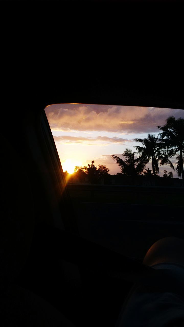 sunset, silhouette, sky, built structure, dark, tree, architecture, orange color, window, cloud - sky, building exterior, sun, sunlight, cloud, nature, house, no people, beauty in nature, indoors, scenics