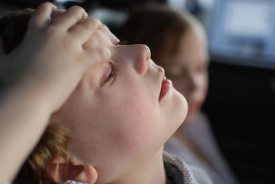 Cropped image of hands on boy head