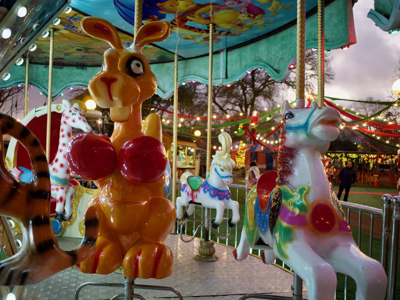 CLOSE-UP OF CAROUSEL HANGING ON AMUSEMENT PARK