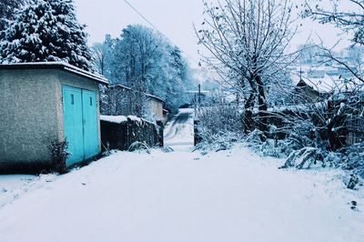 House on field against sky during winter