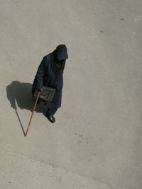 High angle view of woman walking on footpath