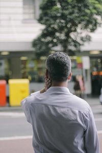 Rear view of man standing on road