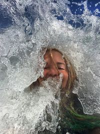 Waves splashing on happy woman