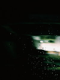 Close-up of water drops against sky at night