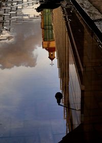 Reflection of modern building in puddle