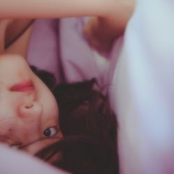 High angle view of woman lying on bed at home