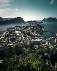 High angle view of townscape by sea against sky