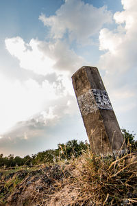 Old abandoned building on field against sky