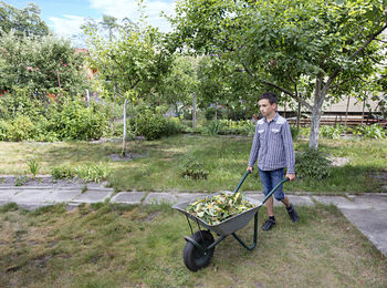 Full length of boy with wheelbarrow at park