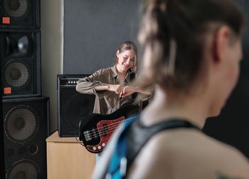 Rock band rehearsal. studio audio check for a female band. musicians with guitars. smiling guitarist 