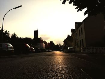 View of city street at sunset