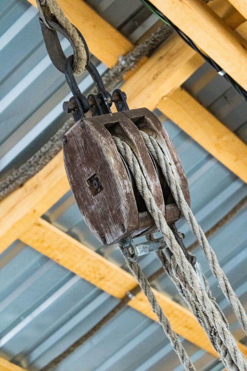 wood, iron, no people, hanging, low angle view, mast, architecture, pulley, wing, indoors, roof, metal, day, industry, equipment, ceiling