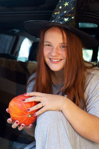 Portrait of a smiling young woman sitting in car