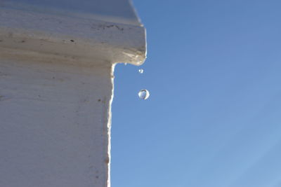 Low angle view of moon against clear blue sky