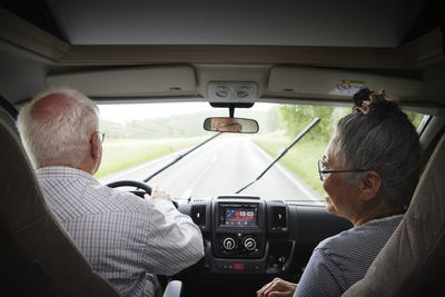 Senior couple traveling by van