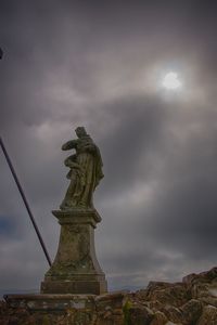 Low angle view of statue against cloudy sky