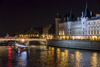 The seine river and the conciergerie illuminated at night