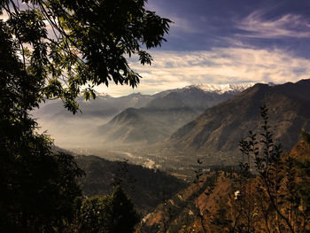 Scenic view of mountains against cloudy sky