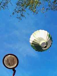 	one hot-air balloon and a streetlight