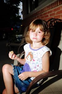 Portrait of girl sitting on chair