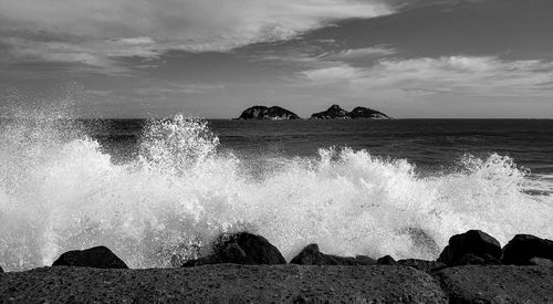 Scenic view of rocks in sea against sky