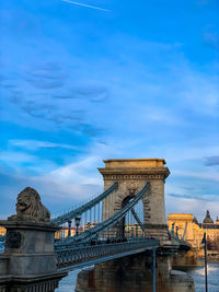 View of bridge over river against cloudy sky