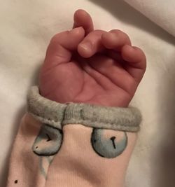 Close-up of hand holding baby feet