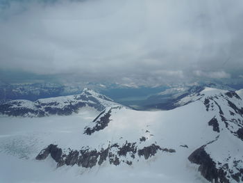 Scenic view of snow covered mountains against sky