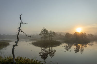 Scenic view of lake against sky during sunset