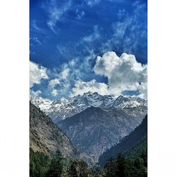 Scenic view of mountains against cloudy sky