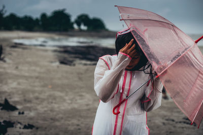 Side view of woman with umbrella