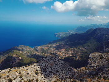 Aerial view of sea and mountains against sky