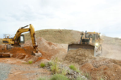 Construction site on landscape against sky