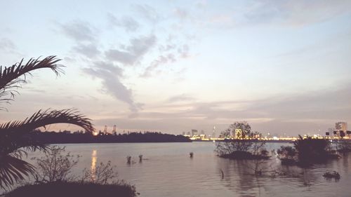 Scenic view of river against sky at sunset