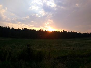 Scenic view of field against sky during sunset