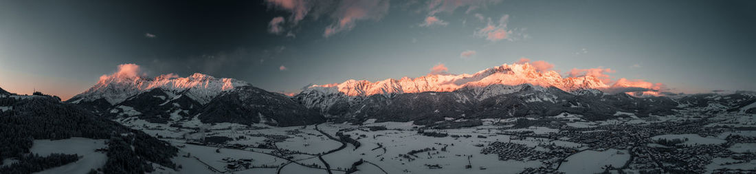 Panoramic view of snowcapped mountains against sky during sunset