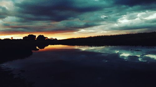 Scenic view of dramatic sky over lake