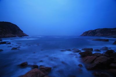 Scenic view of sea against clear blue sky