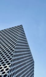 Low angle view of modern building against clear blue sky