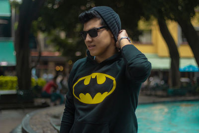 Young man wearing sunglasses standing outdoors