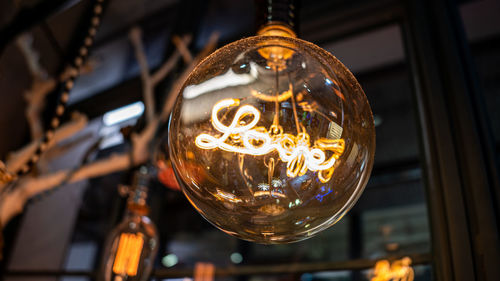 Low angle view of illuminated light bulb