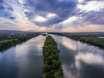 Scenic view of river against sky at sunset