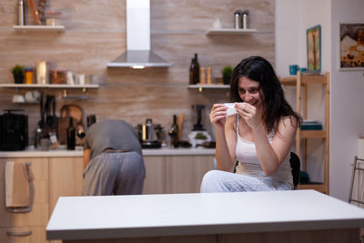 Full length of woman sitting at table