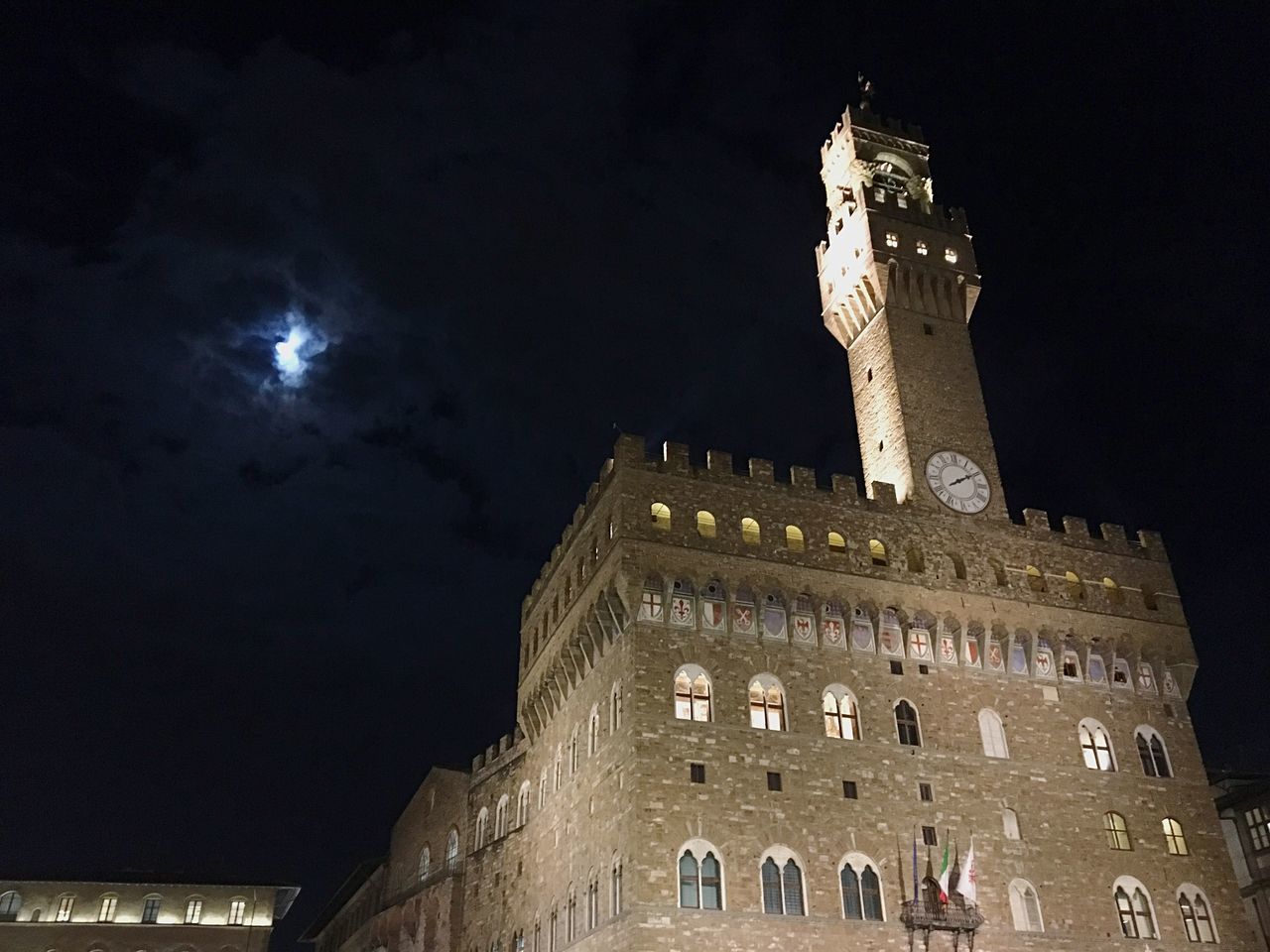 LOW ANGLE VIEW OF ILLUMINATED TOWER AT NIGHT