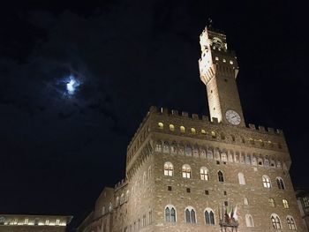 Low angle view of illuminated building against sky at night