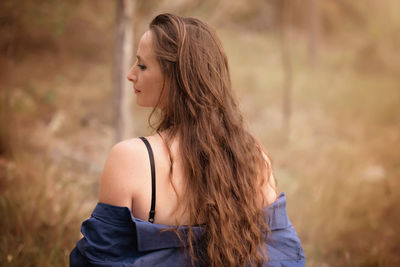 Rear view of young woman standing outdoors