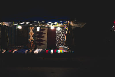 Illuminated lighting equipment against sky at night