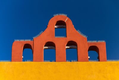 Low angle view of built structure against blue sky